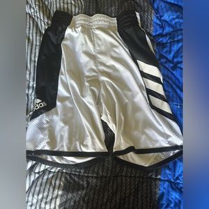 White/black Adidas shorts.